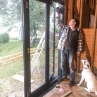 Fitting the bi-fold doors with help from Ziggy.