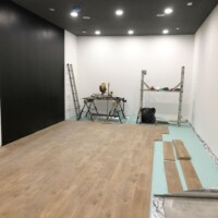 Black wall painted and laying the laminate floor.